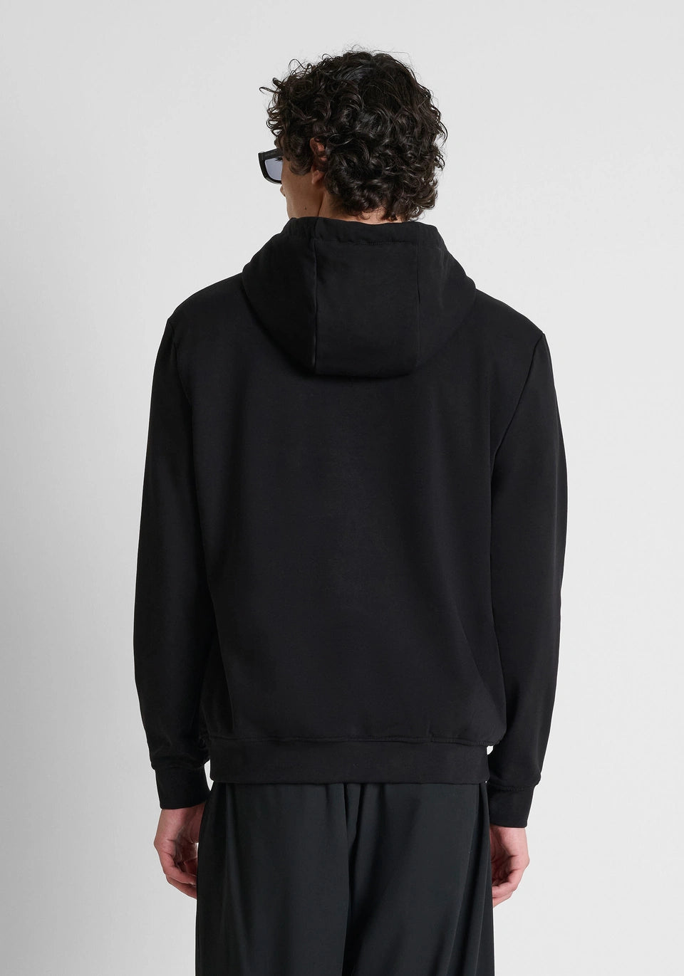 Black relaxed-fit hoodie in cotton fleece with metal plate on heart